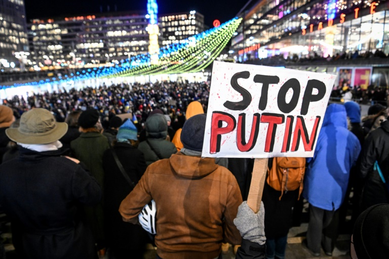 Protesters hold a banner against Russian President Vladimir Putin during a demonstration in Sweden on March 2, 2022
