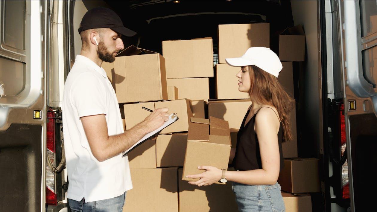 Free Man and Woman Checking the Packages Stock Photo