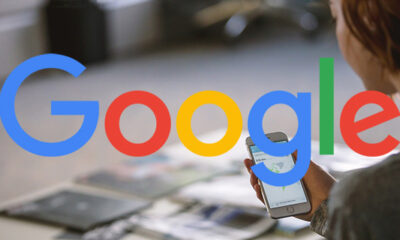 Woman looking at phone with Google logo