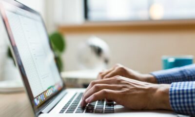 A person typing on a laptop.