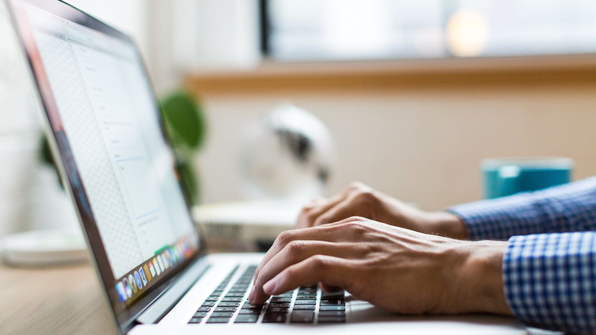 A person typing on a laptop.