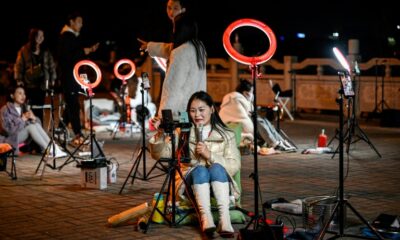 Livestreamers gather on a bridge in the Chinese city of Guilin in the hopes of catching the attention of Douyin users