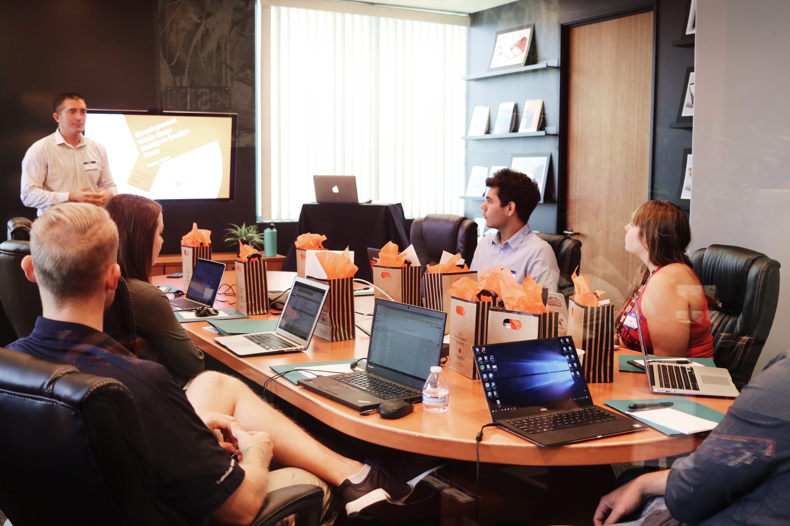 Pictrues showing a group of people in a meeting.