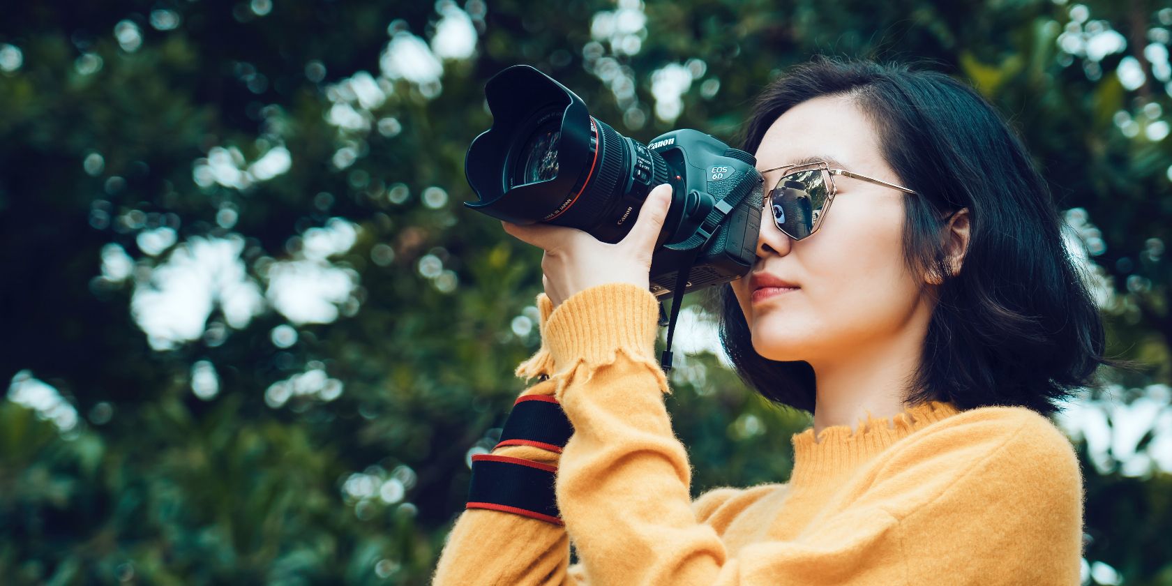 photo of a woman taking photos on her camera