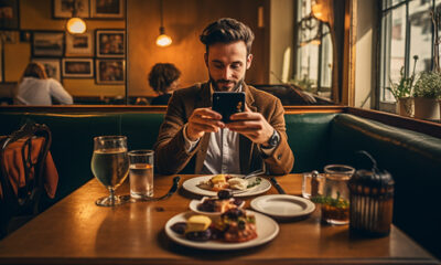 Man Taking Photo Of Food In Restarunt