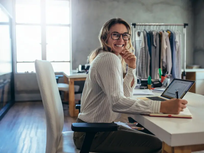 The 19 Best Print on demand Companies to Consider in 2023 + Tips print on demand companies - picture of a woman dropshipping