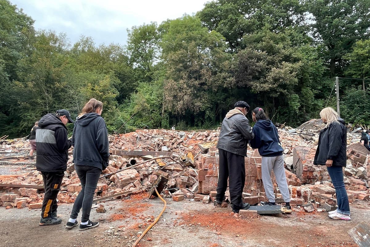Mourners gather at rubble of Crooked House to lament pub’s destruction