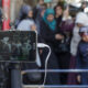 An activist uses a cellphone to live stream as Israeli police forces block Palestinians at an entrance to the Al-Aqsa Mosque compound in Jerusalem's Old City, July 26, 2015. (Faiz Abu Rmeleh/Activestills)