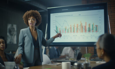 Woman Forecasting In Conference Room