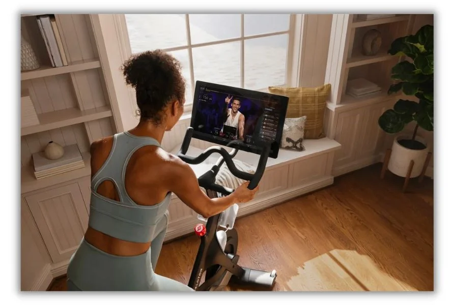 Brand community - Woman riding a peleton bike