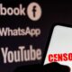 In this photo illustration the word censored is seen displayed on a smartphone with the logos of social networks Facebook, WhatsApp and YouTube in the background.
