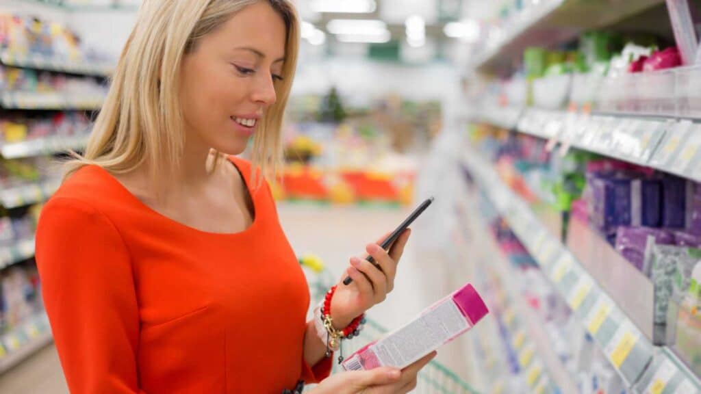 woman buying grocery checking mobile