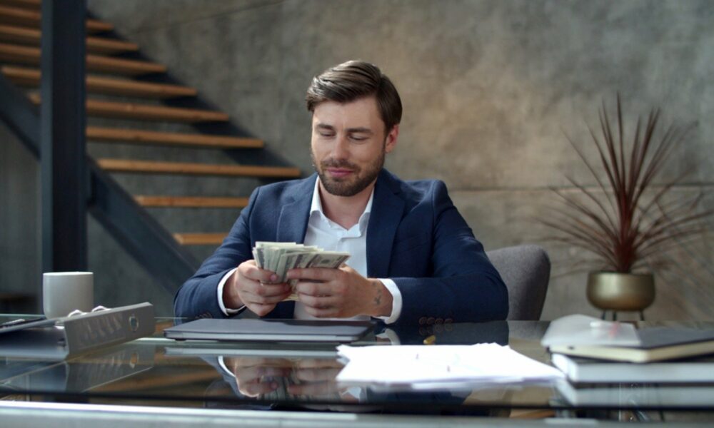 Young businessman counting money