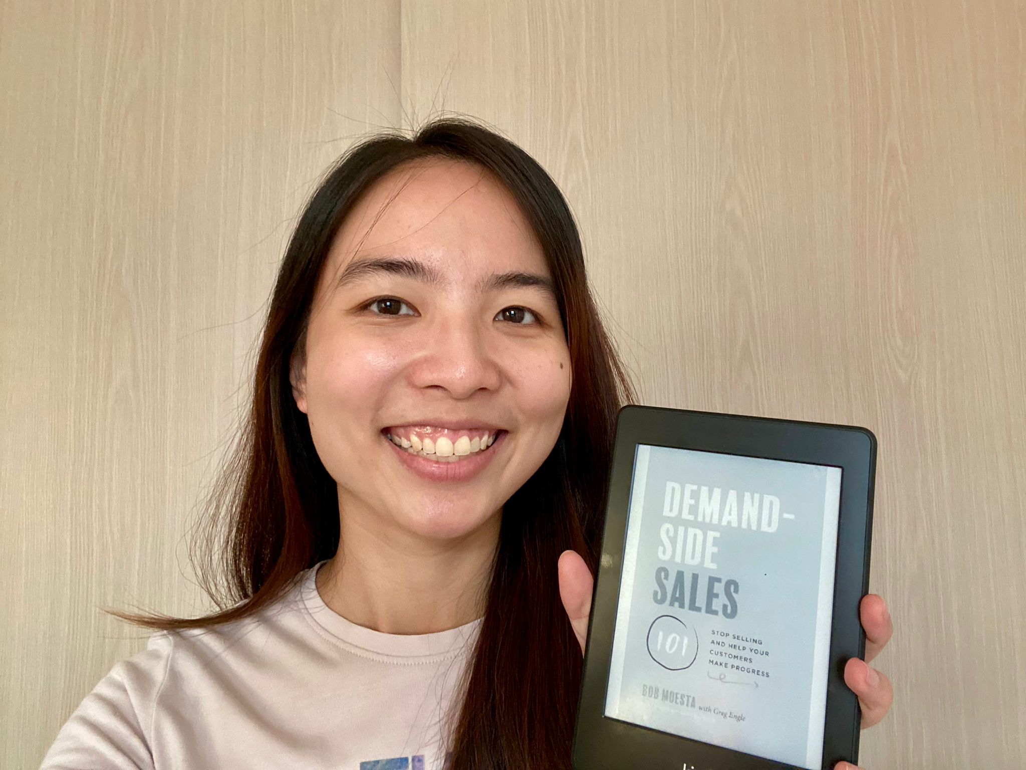 Audrey holding the book Demand Side Sales