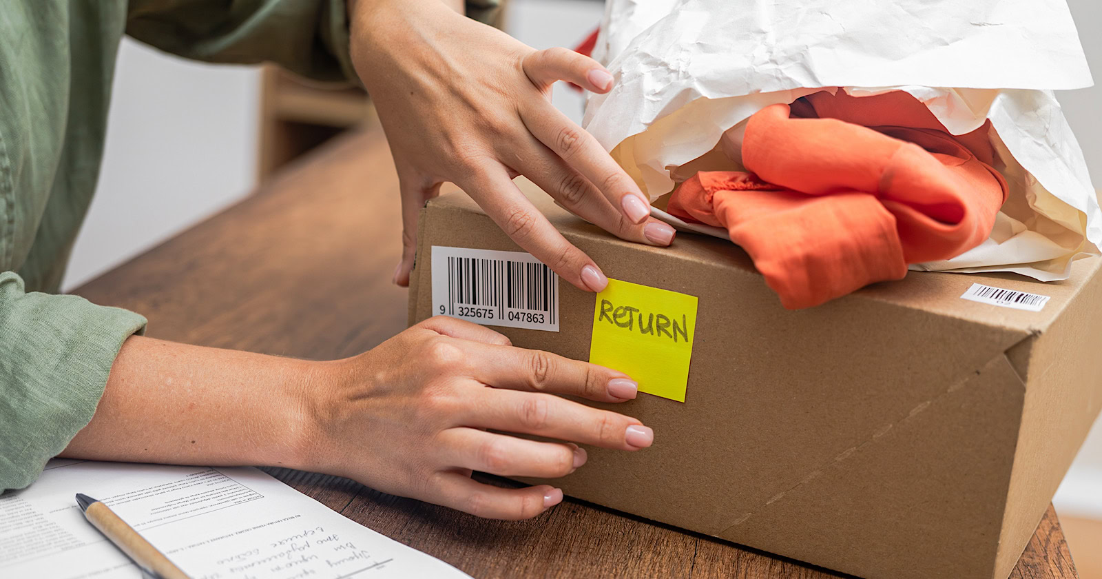 woman online shopper affixes a barcode sticker to a cardboard box, marking it for return and refund