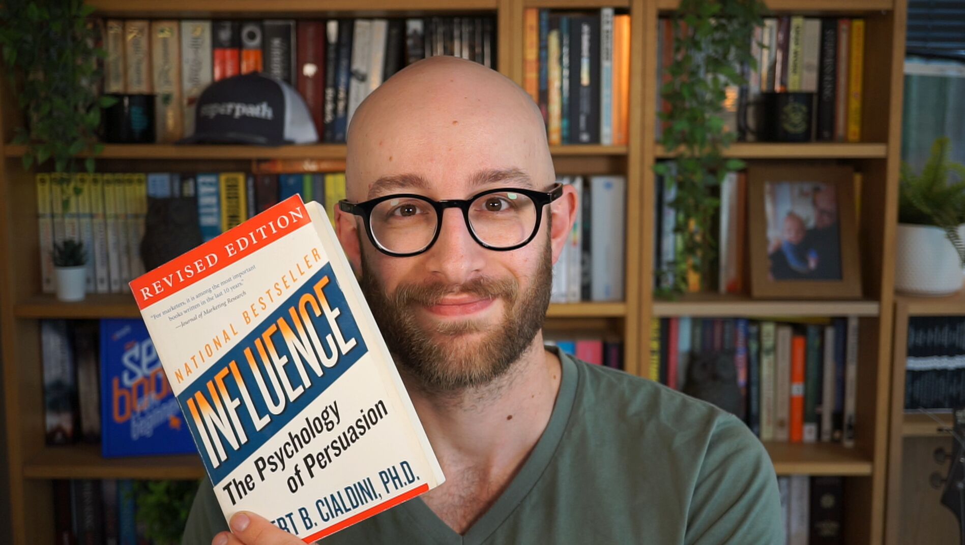 Ryan Law holding the book Influence